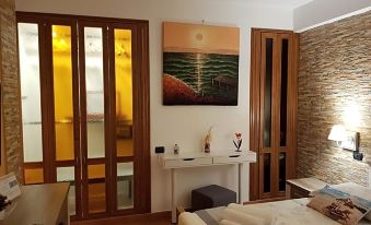 a modern bedroom with wooden doors , a large window , and a table with various items on it at Il Veliero