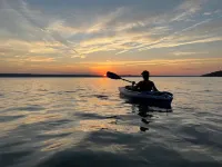 Waterfront retreat on 7 private wooded acres with beautiful sunset views.