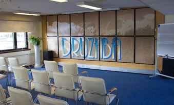 a conference room with chairs arranged in rows and a whiteboard on the wall , possibly for presentations or meetings at Druzhba