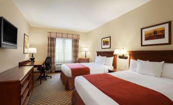 a hotel room with two beds , a window , and lamps , as well as a desk and chair at Country Inn & Suites by Radisson, Manchester Airport, NH