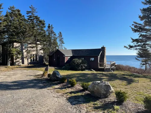 Sunrise Cottage. Relaxing waterfront deck on the rocky shore of Bailey Island.