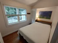 Bright Scandinavian-style cottage with large, private wooded yard