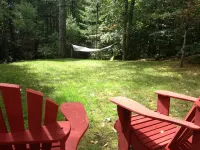 Short walk to village...with private wooded setting. EV Charger in parking area.