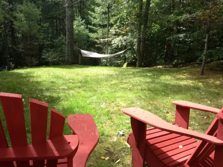 Short walk to village...with private wooded setting. EV Charger in parking area.