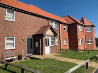 Spacious & homely ground floor apartment in central village location near beach