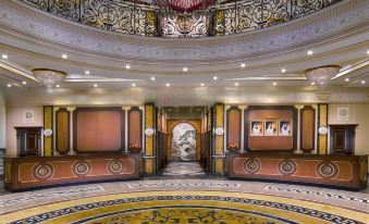 a grand foyer with a marble floor and ornate ceiling , featuring multiple steps leading up to the second floor at Royal Rose Abu Dhabi
