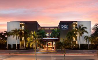 "a large building with palm trees and the words "" four points by sheraton "" written on it" at Four Points by Sheraton Puntacana Village