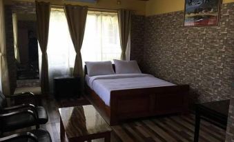 a large bed with white sheets is in a room with wooden floors and furniture at Hotel Football
