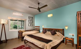 a bedroom with two beds , one on the left and one on the right side of the room at Jungle Hut