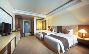 a modern hotel room with two beds , white bedding , and a glass door leading to the bathroom at Muong Thanh Grand Hoang Mai - Nghe An