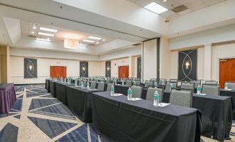 a large conference room with multiple rows of chairs arranged in a semicircle , providing seating for a group of people at DoubleTree by Hilton Richmond - Midlothian