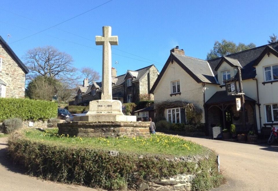 a small village with a cross on top of a monument in the middle of a circle at The Durant Arms