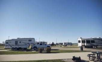 a row of recreational vehicles parked in a campground , with clear blue skies above at Jackpot Junction Casino Hotel