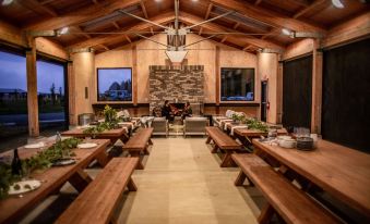 a large dining room with wooden tables and benches arranged for a group of people at Bay Point Landing