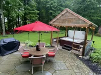 Cabin rental with Hot Tub, Fire Pit, mini fountain pond, hammocks, corn hole.