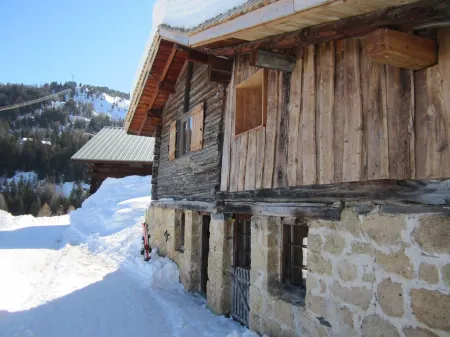 Typical Savoyard chalet with roof shingles, tufa walls and foist