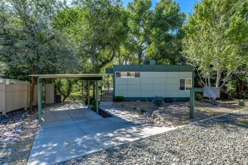 Modern cabin hidden among the trees-- Unwind and relax on the porch creek-side.