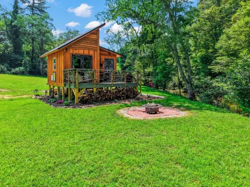 Tiny cabin sits by a bubbling, stocked creek. Pet friendly for a fee, hot tub