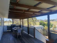 Indoor/outdoor pet-friendly beach house next to world-class beach and river.