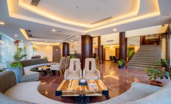 a modern hotel lobby with a wooden coffee table in the center and comfortable seating at Aagantuk Resort