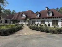 Escape to this serene 4-bedroom home set on 10 private acres.