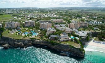 aerial view of a coastal town with buildings and a pool , surrounded by the ocean at The Crane Resort