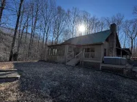 Cabin with hot tub, fire pit, and fishing pond.