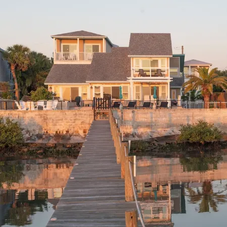 Waterfront home with dock, heated pool, & spectacular views- walk/bike downtown!
