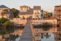 Waterfront home with dock, heated pool, & spectacular views- walk/bike downtown!