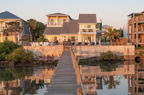 Waterfront home with dock, heated pool, & spectacular views- walk/bike downtown!