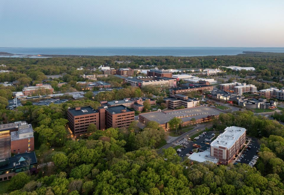 aerial view of a city with buildings and trees , taken from an elevated perspective on a clear day at Hilton Garden Inn Stony Brook