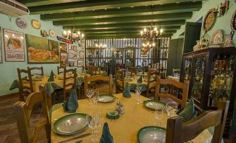 a restaurant with a large dining room , filled with tables and chairs , set for a meal at Hostal Valencia