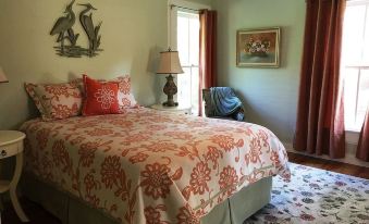 a bedroom with a large bed , a chair , and a painting on the wall at Dolan House B&B