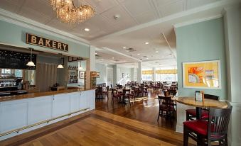a large , elegant restaurant with wooden floors and blue walls , filled with tables and chairs at Mills Park Hotel