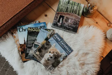 Tiny cabin amongst trees on a farm with alpacas