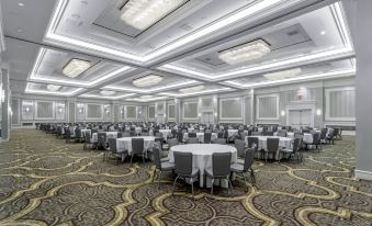 a large banquet hall with multiple rows of tables and chairs , all set up for a formal event at Hilton Columbus at Easton