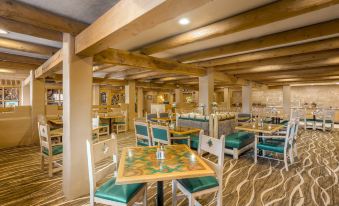 a large dining room with wooden tables and chairs arranged for a group of people to enjoy a meal together at Holiday Inn Canyon de Chelly (Chinle)