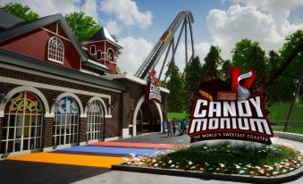 an amusement park entrance with a roller coaster visible in the background , surrounded by trees at Country Inn & Suites by Radisson, Harrisburg Northeast - Hershey