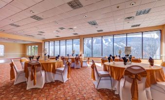 a large dining room with tables and chairs set up for a formal event , possibly a wedding reception at The Chateau Resort