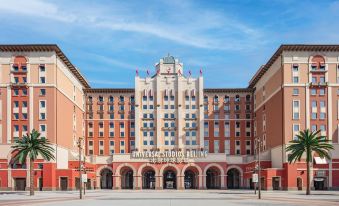 "A large brick building with the word ""hotel"" on its side is shown in the front, along with another photo" at The Universal Studios Grand Hotel