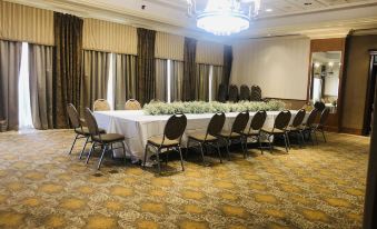 a large conference room with a long table and multiple chairs arranged for a meeting at Hotel Executive Suites