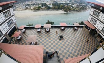 an aerial view of a resort with a checkered floor and several tables and chairs at Hotel River Valley