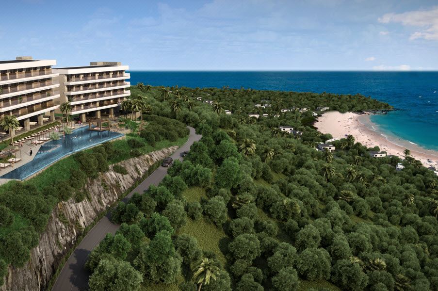 a large resort with a pool , surrounded by trees and mountains , overlooking the ocean at Wyndham Tamarindo