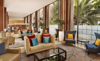 a hotel lobby with a large seating area , featuring several couches and chairs arranged around a coffee table at Sheraton Skyline Hotel London Heathrow