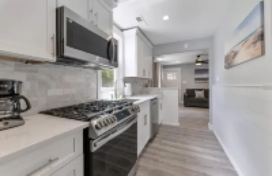 Stainless Steel Appliances and Flat-Screen TV - Modern Coastal Retreat