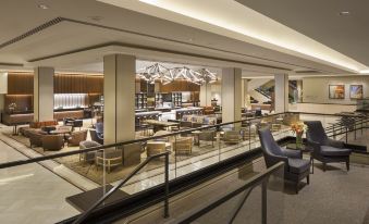 a modern lounge area with multiple couches and chairs , creating a comfortable and inviting atmosphere at Hilton San Francisco Union Square