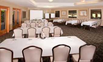 a large conference room with multiple tables and chairs arranged for a meeting or event at Singing Hills Golf Resort