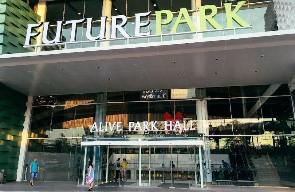 "the entrance to the "" alive park hall "" building , with a sign above the door and people walking in front of it" at Venice Resort