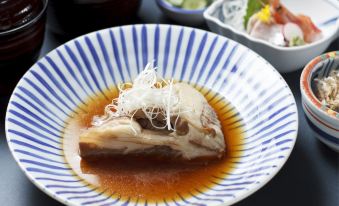 a plate of food on a dining table , with a variety of dishes and utensils at Fukui Hotel