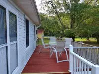 The Lake House at Turtle Cove: Cozy relaxing lake home with dock on wooded lot.